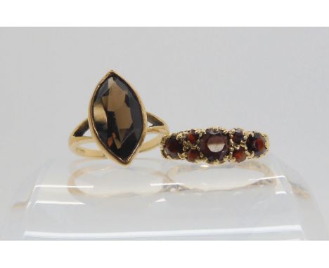 A 9ct gold marquis shaped smoky quartz ring, size K, together with a garnet set ring, size L1/2, weight together 5.6gms Condi