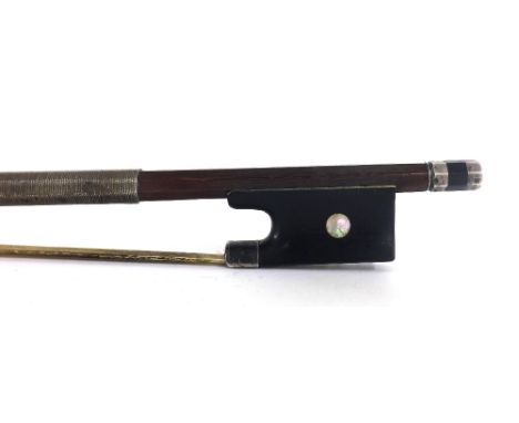 Interesting silver mounted violin bow, unstamped, the stick octagonal, the ebony frog inlaid with pearl eyes and the ebony ad