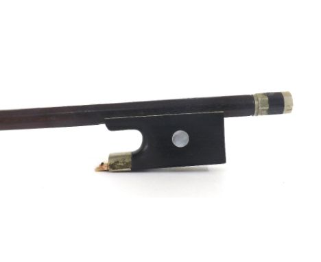 French nickel mounted violin bow by C.N. Bazin and stamped Tourte, the stick round, the ebony frog inlaid with pearl eyes and