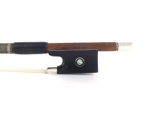 Silver mounted violin bow stamped Atelier Duhaut á Tours, the stick round, the ebony frog inlaid with silver rings enclosing 