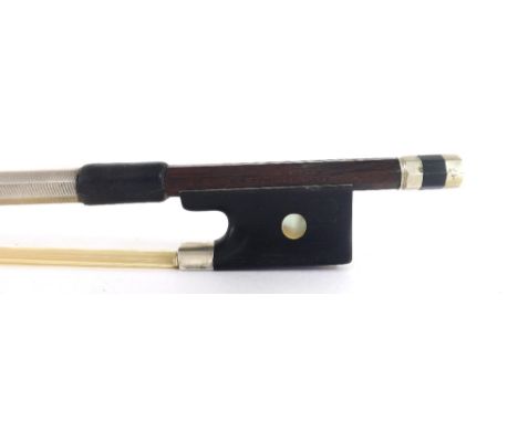 German silver mounted violin bow stamped H.R. Pfretzschner, the stick round, the ebony frog inlaid with pearl eyes and the eb