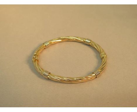 A 9ct bi colour hallmarked bangle/bracelet - 6cm x 5.5cm - sprung hinge, good overall condition - weight approx 8.2 grams 