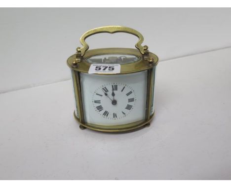 A French oval shaped brass cased carriage clock - oval shaped - approx 8cm x 10cm - working in saleroom - with key 