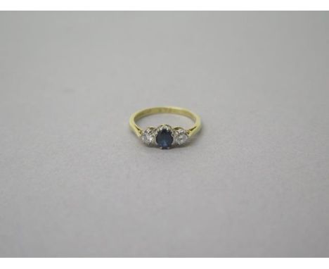 An 18ct yellow gold (hallmarked) three stone sapphire and diamond ring size K/L - weight approx 2.5 grams 