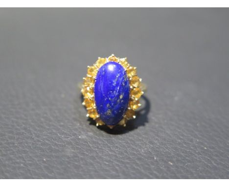 An 18ct yellow gold Lapis Lazuli and citrine ring - the central oval Lapis approx 1.5cm surrounded by 16 citrines - ring size