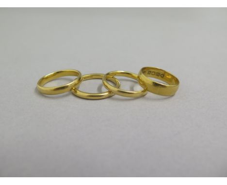 Four 22ct yellow gold wedding bands - sizes R,P,M/N &amp; K/L - total weight approx 17.2 grams 