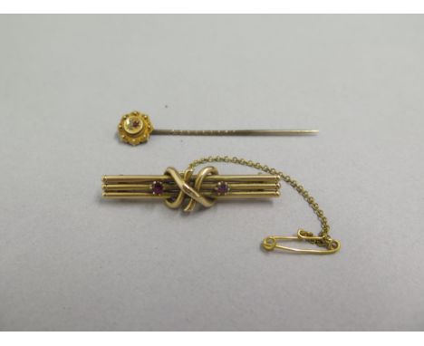 A 14ct yellow gold (un hallmarked but tested) brooch with rubies approx 4cm - weight approx 3.8 grams and a tie pin with ruby