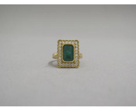 A very good 18ct yellow gold (hallmarked) emerald and diamond ring - the rectangular step cut emerald approx 2.28ct surrounde