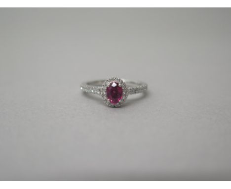 A platinum ruby and diamond ring - diamonds well matched, bright and lively - head size approx 8mm x 7mm with diamond shoulde