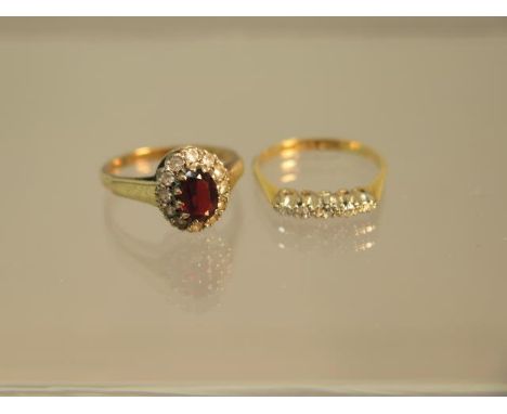 Two gold rings - One 18ct yellow gold and diamond - ring size L/M - weight approx 1.7 grams - one 9ct yellow gold with garnet