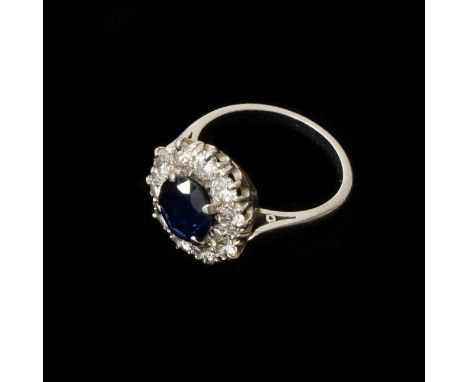 A good sapphire and diamond cluster ring - central sapphire approx 7mm diameter surrounded by 10 round brilliant cut diamonds