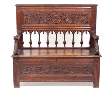 A CARVED OAK MONK'S STYLE BENCH  with galleried arcaded back with scrolling ferns and baluster balustrade, 108cm wide x 111cm