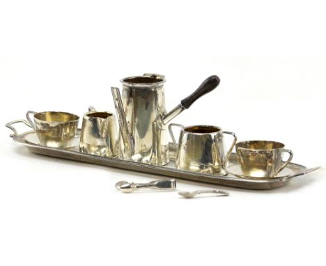 A MINIATURE SILVER TEA SERVICE with pot (lid deficient), two tea cups, cream jug and sucrier on tray, 13cm across, bearing ma