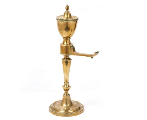 A 19TH CENTURY BRASS COLZA OIL LAMP with urn shaped reservoir, outset spout and turned stem on a spreading circular base, 43c