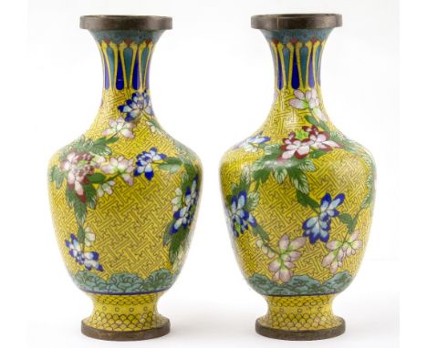 A PAIR OF CLOISONNE ENAMEL BALUSTER VASES on yellow ground, decorated with leaves and flowers 27cm high, unsigned (2)