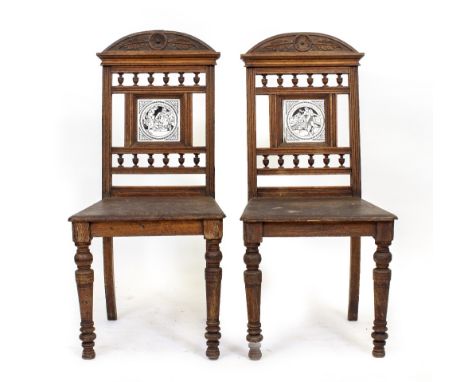 A PAIR OF EDWARDIAN MAHOGANY CARVED HALL CHAIRS with turned balustrade backs on turned tapering forelegs with black and white