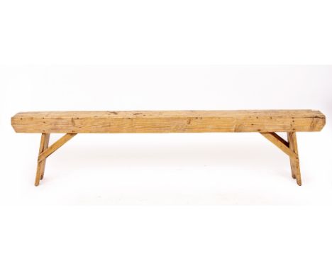 A LATE 19TH / EARLY 20TH CENTURY ELM RUSTIC BENCH  on carved panel ends supported by arched stretcher, 207cm long x 23cm deep