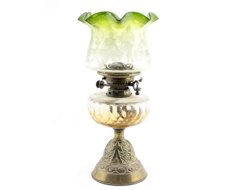 A LATE 19TH / EARLY 20TH CENTURY OIL LAMP with a green glass shade, a cut glass well and a brass base, 43.5cm high