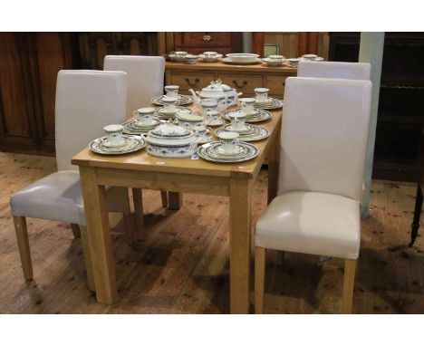 Light oak six piece dining suite comprising three door sideboard extending dining table and four faux leather chairs