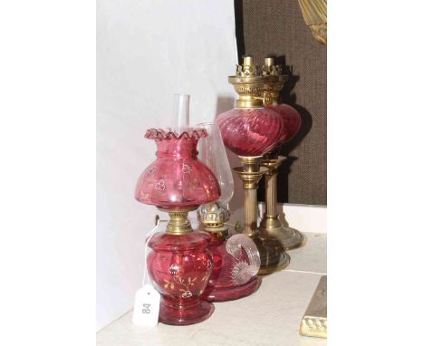 Four small ruby glass and brass oil lamps
