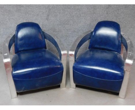 A pair of vintage style aviator armchairs in azure leather upholstery. H.74 W.73 D.83cm 