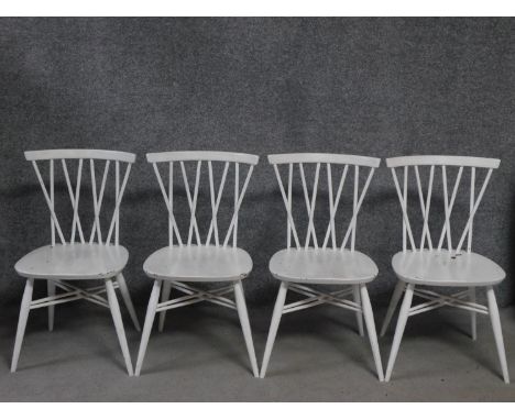 A set of four vintage white painted Ercol style dining chairs, British Standards kitemark stamped to base. H.79cm 