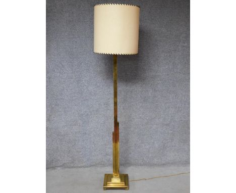 An Art Deco brass standard lamp of geometric outline and square stepped base resting on four block feet. H.200cm 