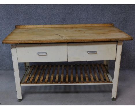 A vintage pine topped and metal framed kitchen side table fitted with two frieze drawers on square section supports united by