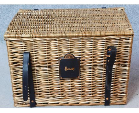 A Harrods wicker hamper basket. H.38 W.56 D.38cm 