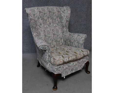 A vintage beech framed Parker Knoll wingback armchair. H.97cm 