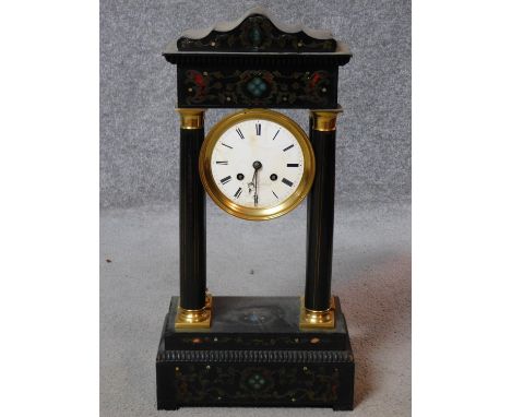 An antique French ebonised portico clock with tortoiseshell and brass inlaid detailing. White enamel dial with roman numerals