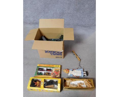 A collection of vintage toys to include two Pelham puppets, a set of 'Famous Cars of Yesteryear' miniature cars and a box of 