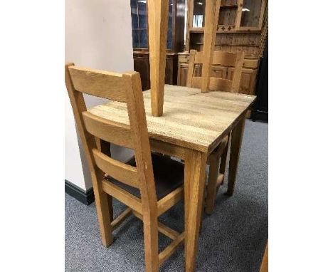 A square oak table and pair of ladder back chairs 