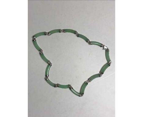 A silver and green jade necklace