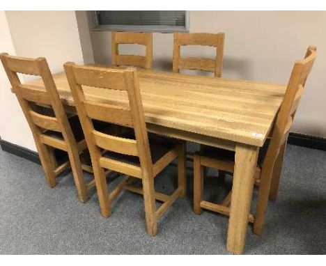 A rectangular oak table and five ladder back chairs 