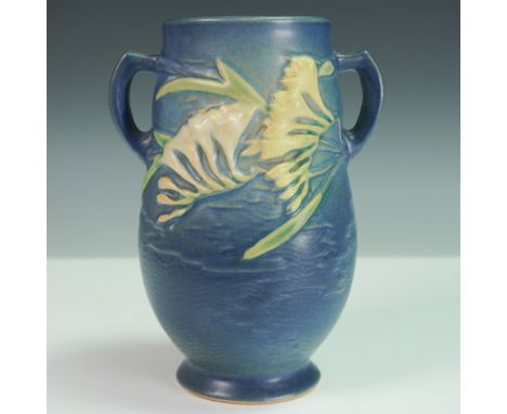 Roseville Pottery vase in the Freesia pattern, shape number 120-7, finished in a rich blue glaze with detailed raised yellow 