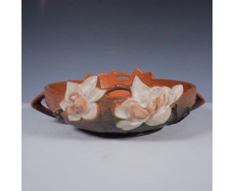 Crafted by Roseville Pottery, this Magnolia bowl features the distinctive raised blossom design in warm earth tones with crea