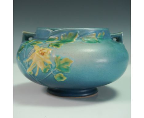 This vintage Roseville Columbine jardiniere, shape number 655-4", features a soft matte blue glaze accented with raised yello