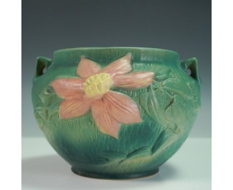 A classic example of Roseville Pottery, this jardinière from the Clematis line features raised pink blossoms with yellow cent