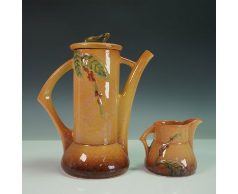 A vintage Roseville Pottery Wincraft coffee pot and creamer set in a warm brown and amber glaze, featuring a molded relief of