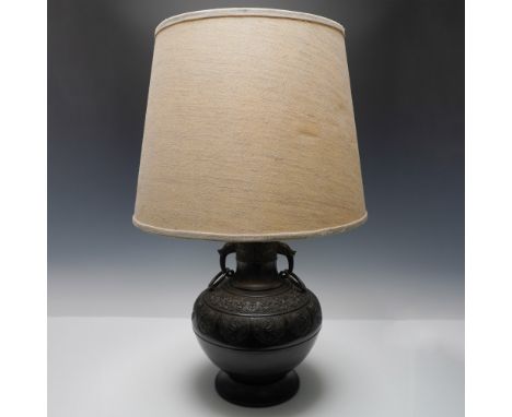 Elegant cast metal table lamp featuring an intricately embossed design with phoenix and dragon motifs, symbolizing prosperity