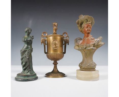 An intriguing collection of three decorative pieces, each showcasing unique artistic craftsmanship. The set includes a verdig