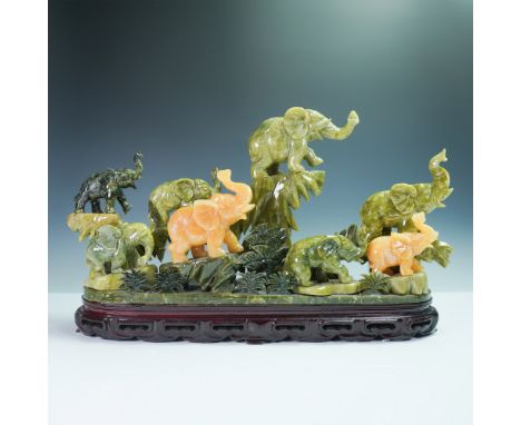 Exquisite mixed mineral carved elephant sculpture depicting a majestic herd in motion. Crafted from a variety of polished min