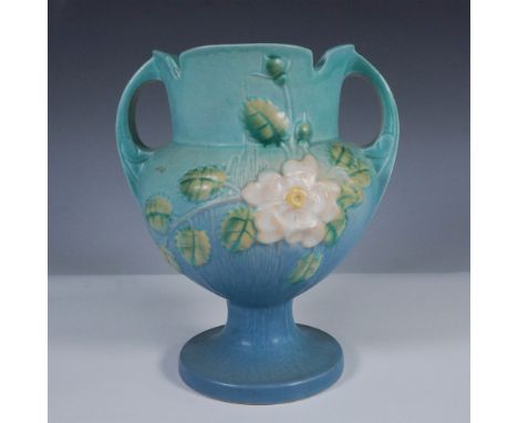 Vintage Roseville Pottery vase in the White Rose pattern, shape number 147-8, showcasing an elegant footed base and dual hand