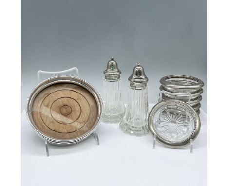 This lot includes 6 silver plated overlay glass coasters, a wooden tray with a sterling silver exterior, and silver toned gla