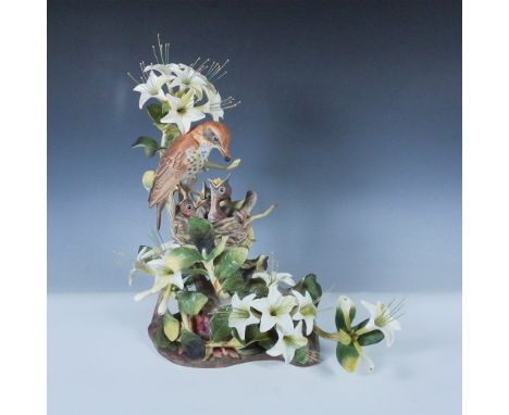 Exquisitely crafted Boehm porcelain sculpture featuring a pair of wood thrushes perched amidst detailed foliage. This limited