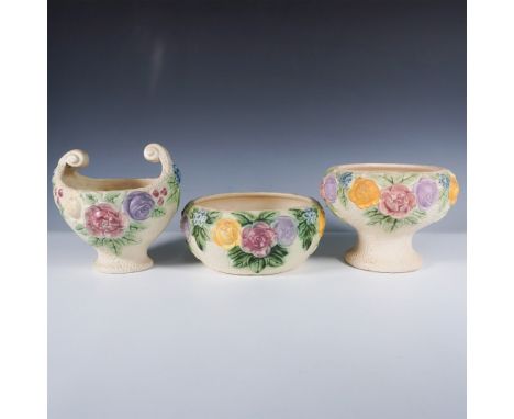 Charming set of three Roseville Rozane pottery pieces, each featuring colorful raised floral motifs in shades of yellow, pink