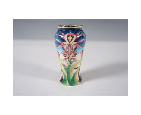 A Moorcroft enamel miniature vase designed by Philip Gibson, featuring a hand-painted depiction of pink Lizard Orchid flowers