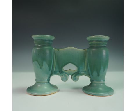 This distinctive Roseville Pottery candle holder features a two-taper design in the Carnelian line, finished in a soft matte 