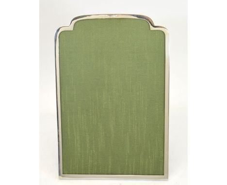 A George V silver photo frame, plain form with cushion domed top and green silk backing, wooden easel support, Sanders &amp; 